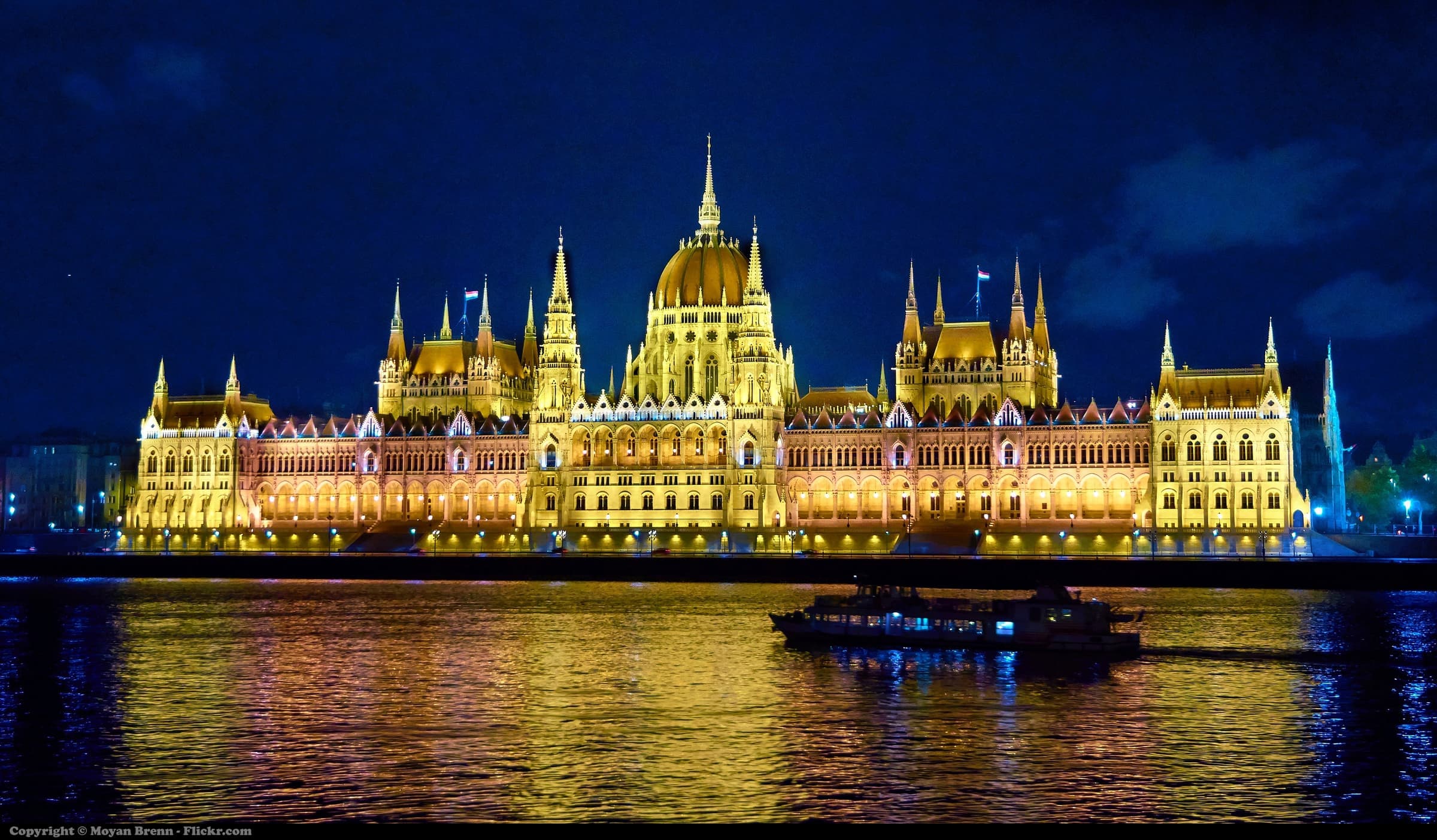 The Hungarian Parliament lit gold above the Danube at night